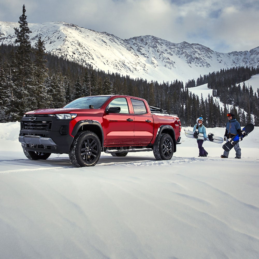 Man and woman standing next to Buick car
